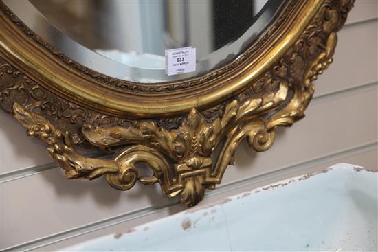 A large Victorian oval gilt wall mirror, 4ft 7in.